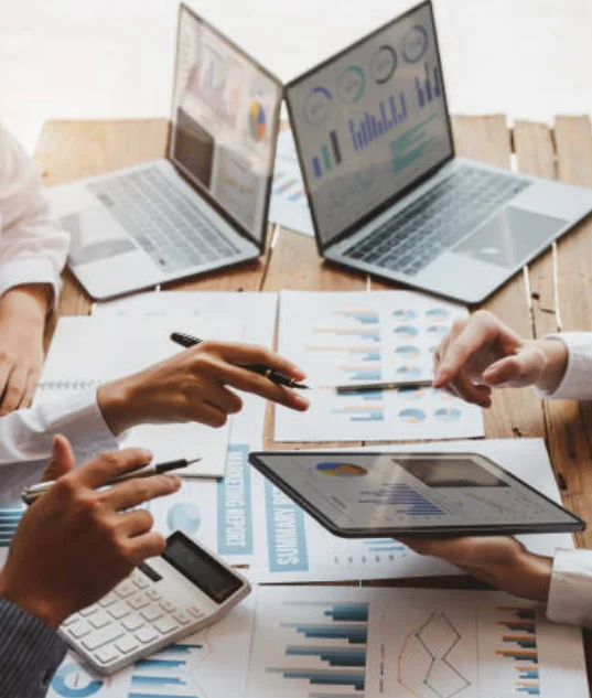 In a productive workspace, business workers collaborate using computers and documents